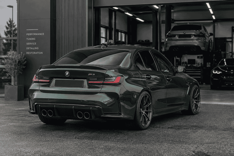 Rear three-quarter concept of a green BMW G80 M3 with a carbon trunk lip spoiler