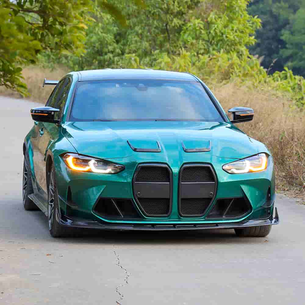 Front view of a green BMW with lower bumper styling.
