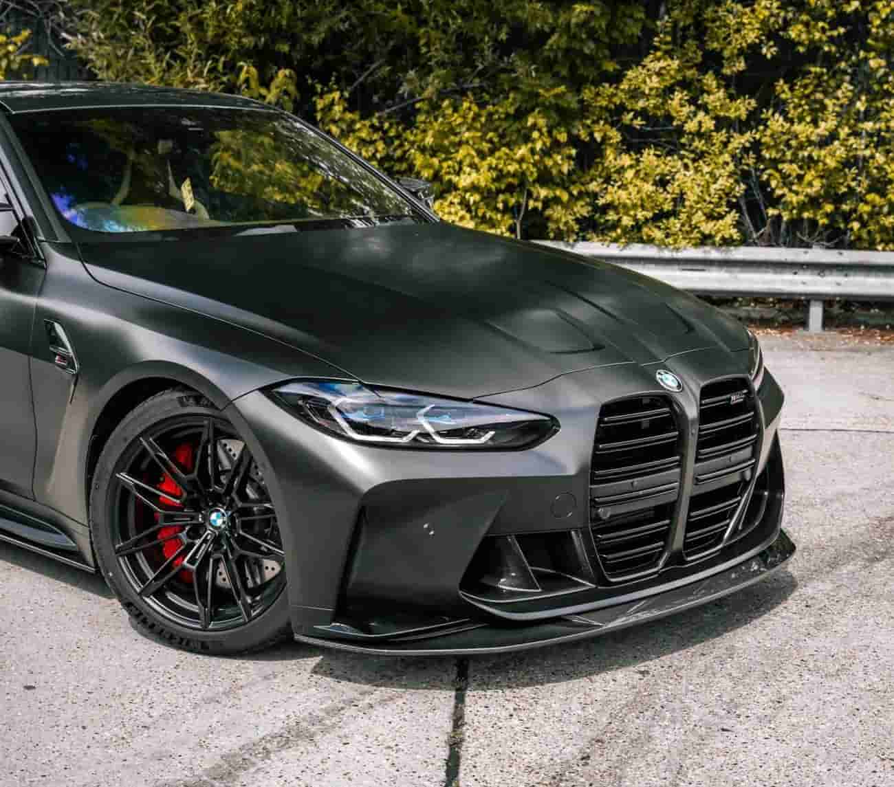Front-quarter view of a dark BMW with front styling.