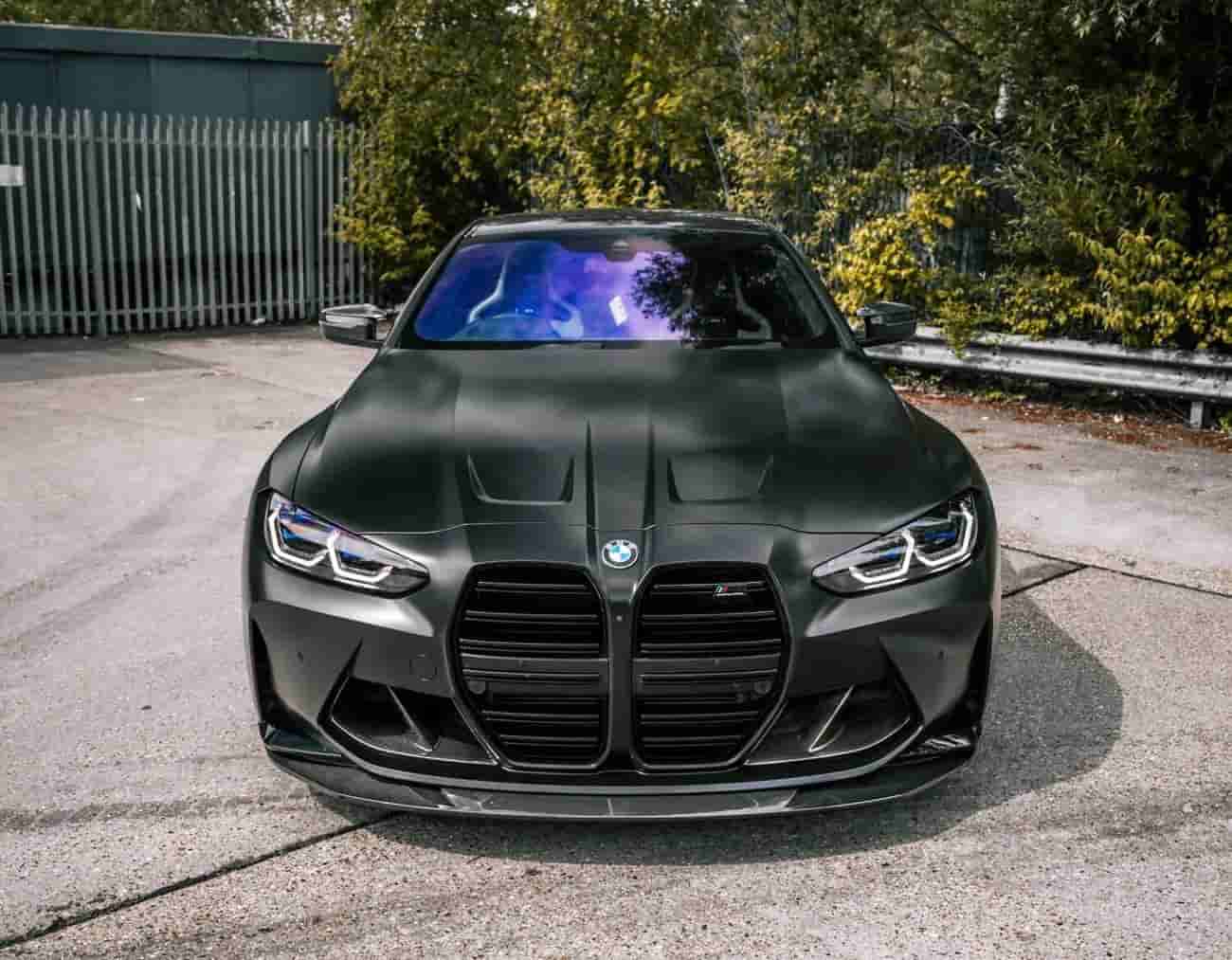 Front view of a dark BMW with a front lip.