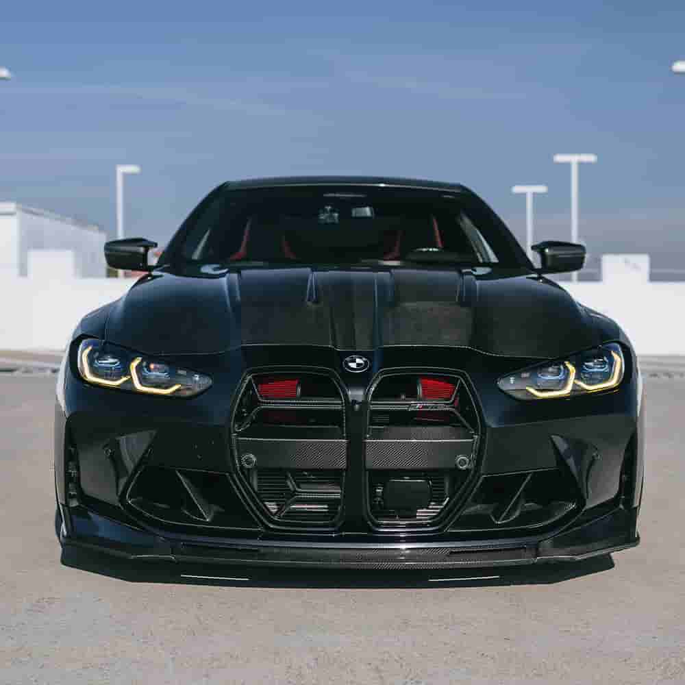 Front view of a dark BMW with grille styling changes.