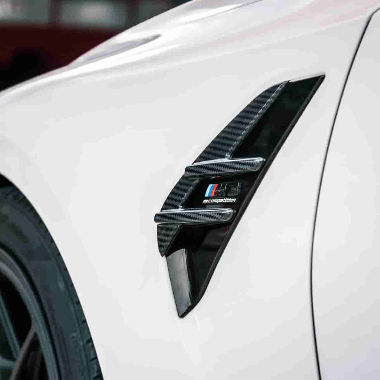 Fender vent detail on a white vehicle.