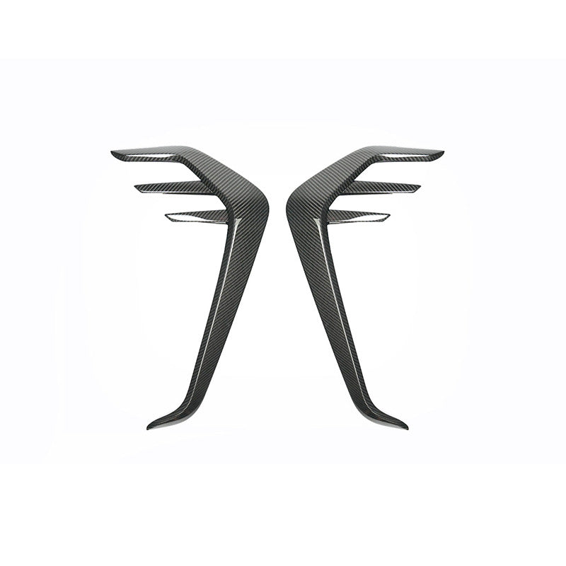 Pair of tall fender vent trim pieces with projecting fins.