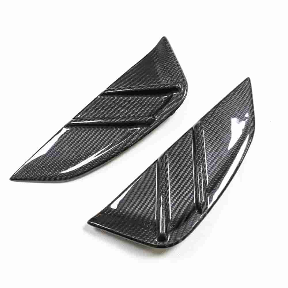 Pair of finned fender vent trim pieces.
