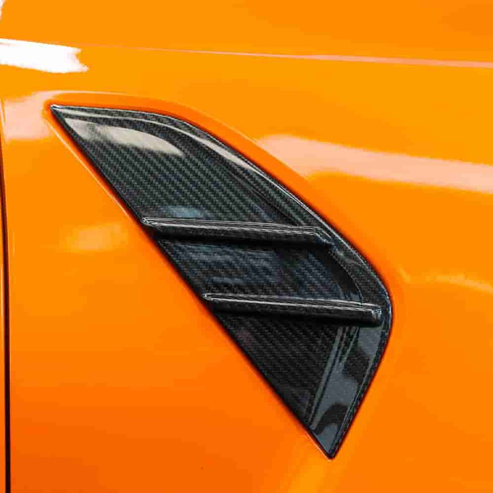 Close fender trim reference on an orange vehicle.