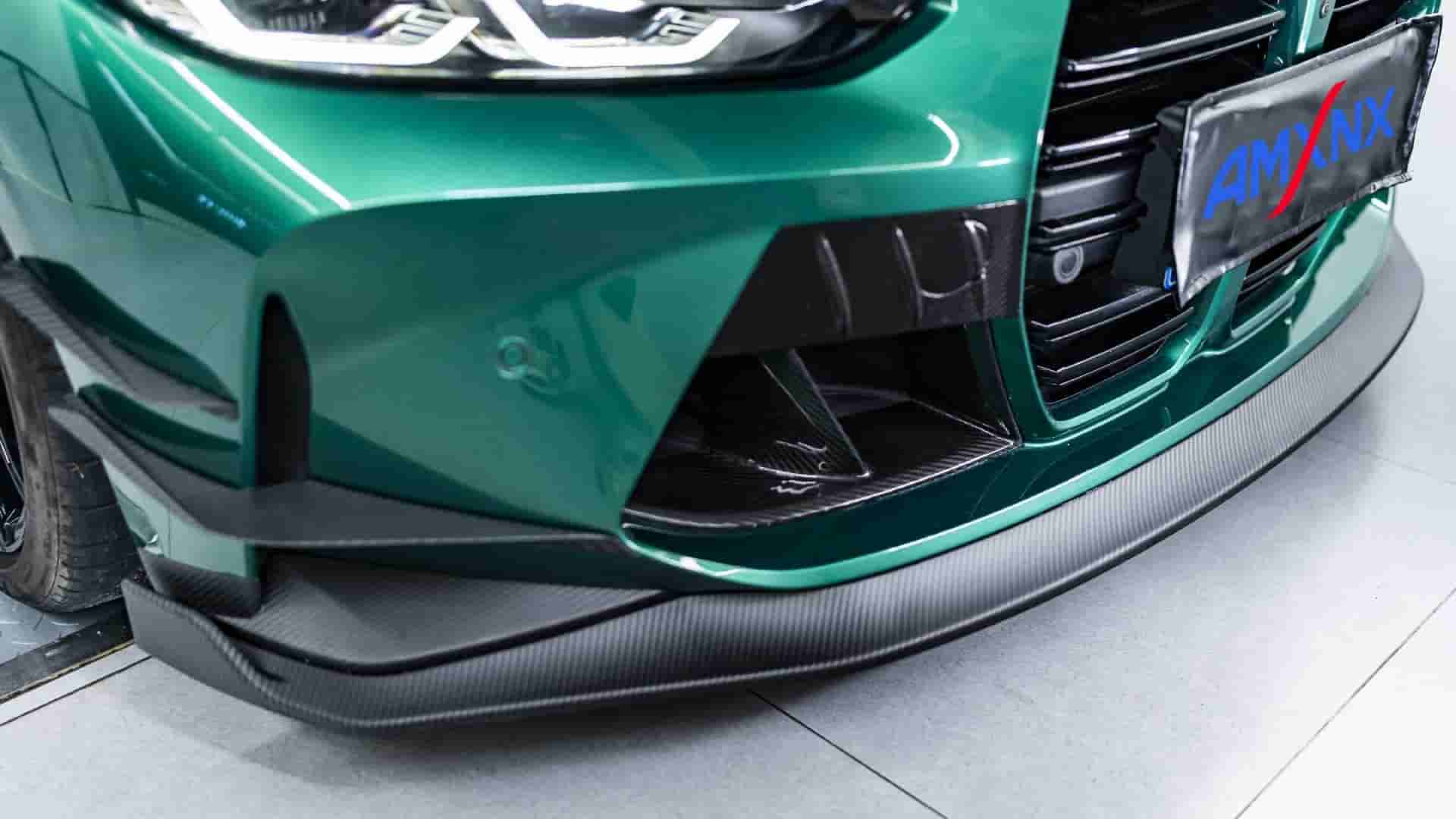 Close view of the front corner and lip on a green BMW.