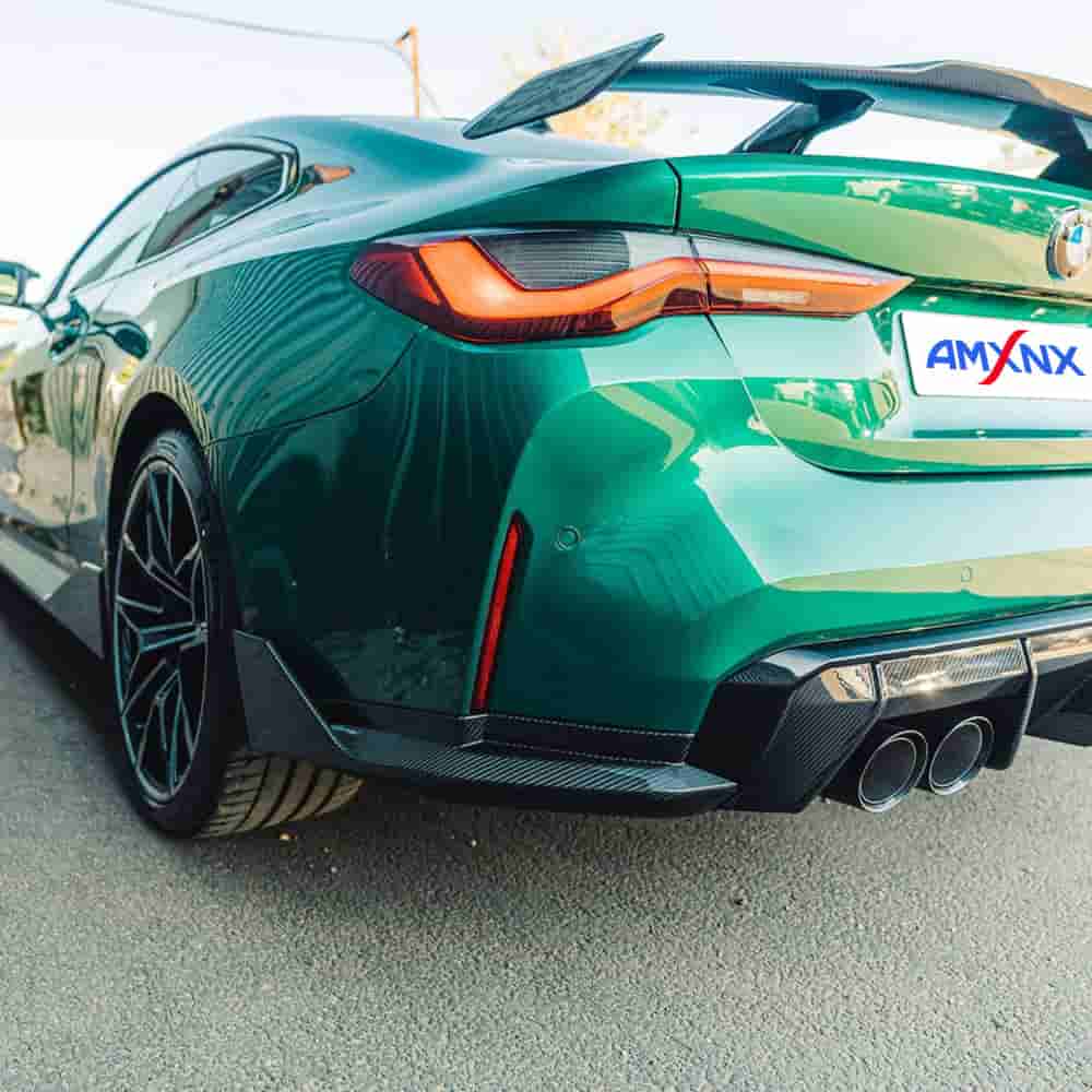 Rear-quarter view of a green coupe with lower bumper styling.