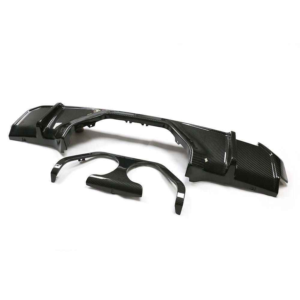 Rear diffuser components with a central exhaust opening surround.