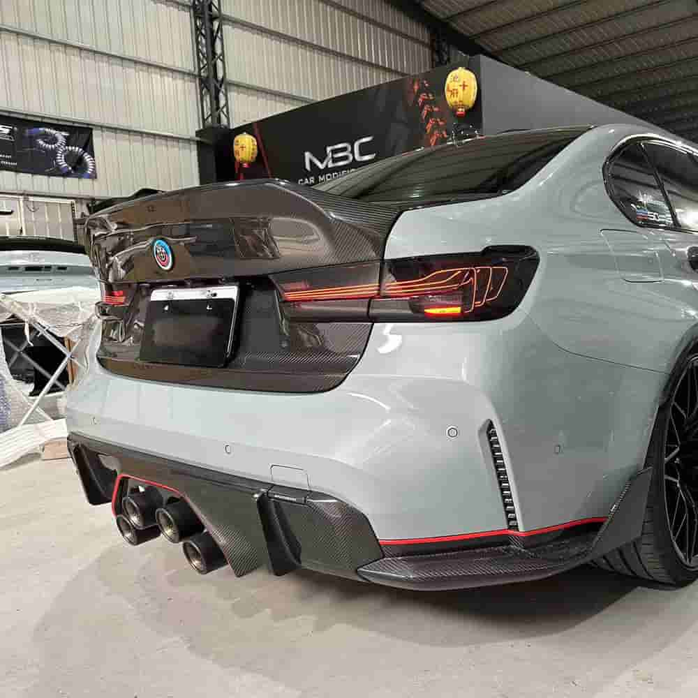 Opposite rear-quarter view of a gray BMW with a diffuser.