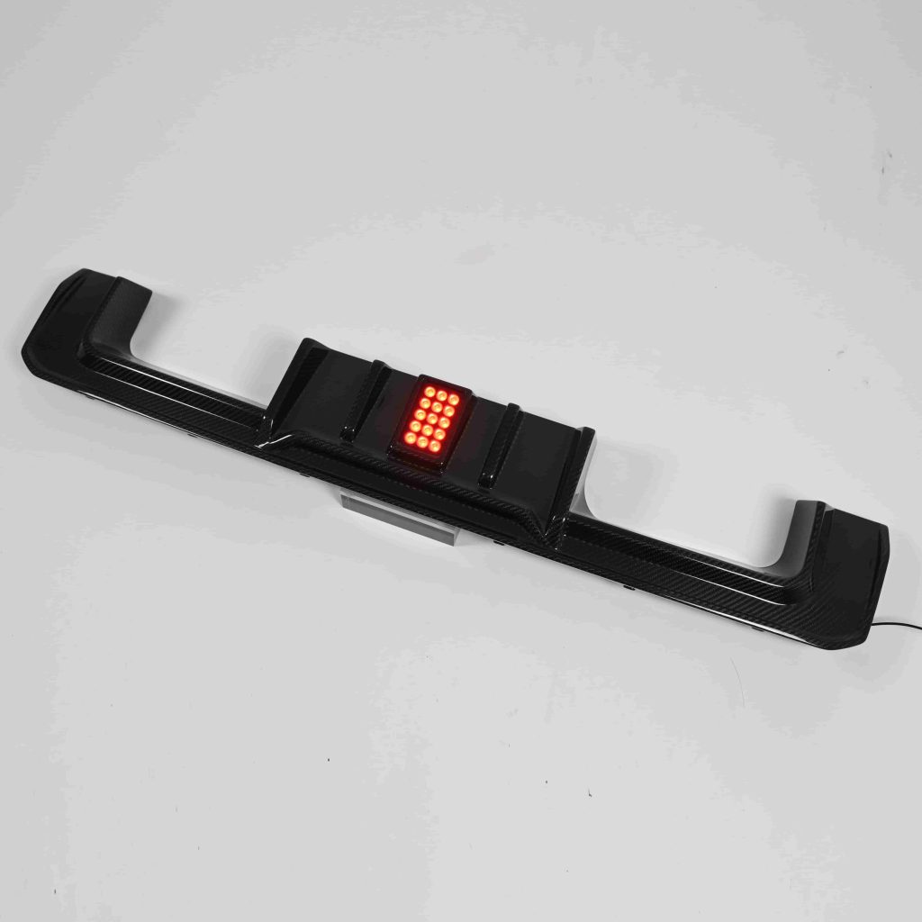 Rear diffuser with a rectangular red light in its center.