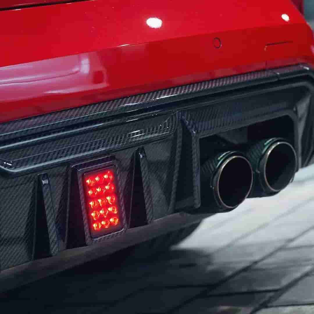 Rear-bumper close-up showing a center light and exhaust tips.