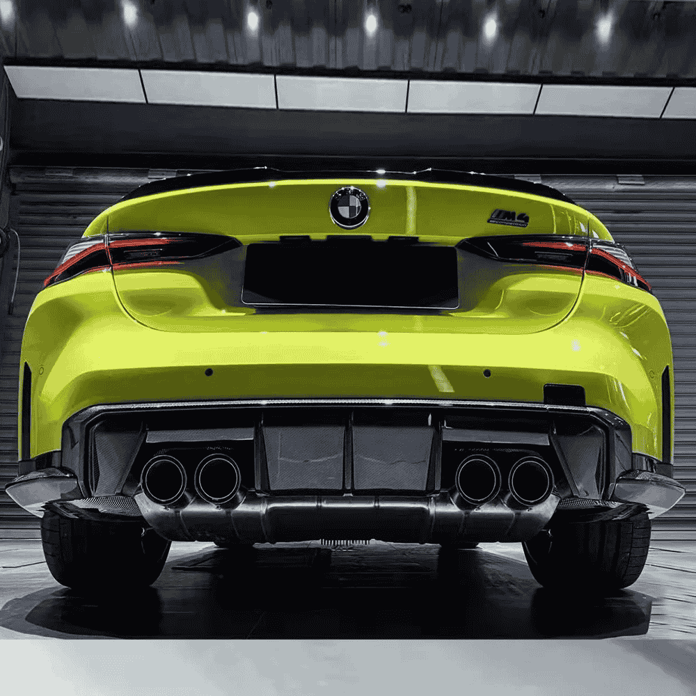 Rear view of a green car with exhaust outlets and styling parts.