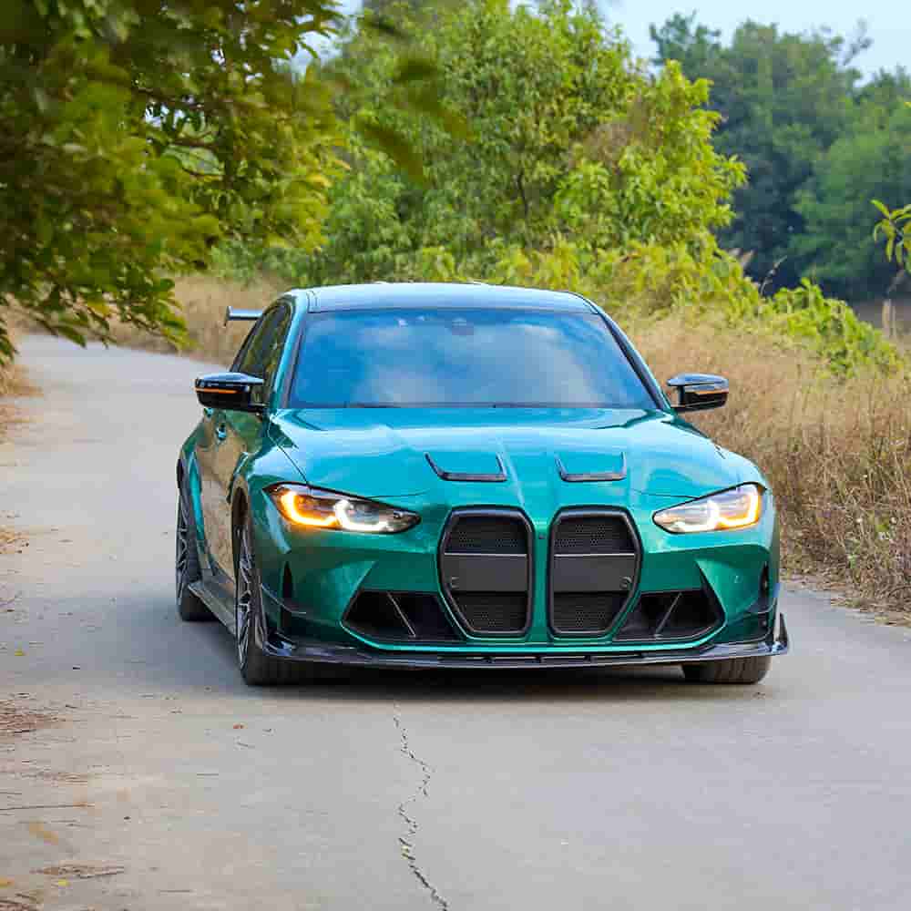 Front view of a green sedan with exterior styling parts.