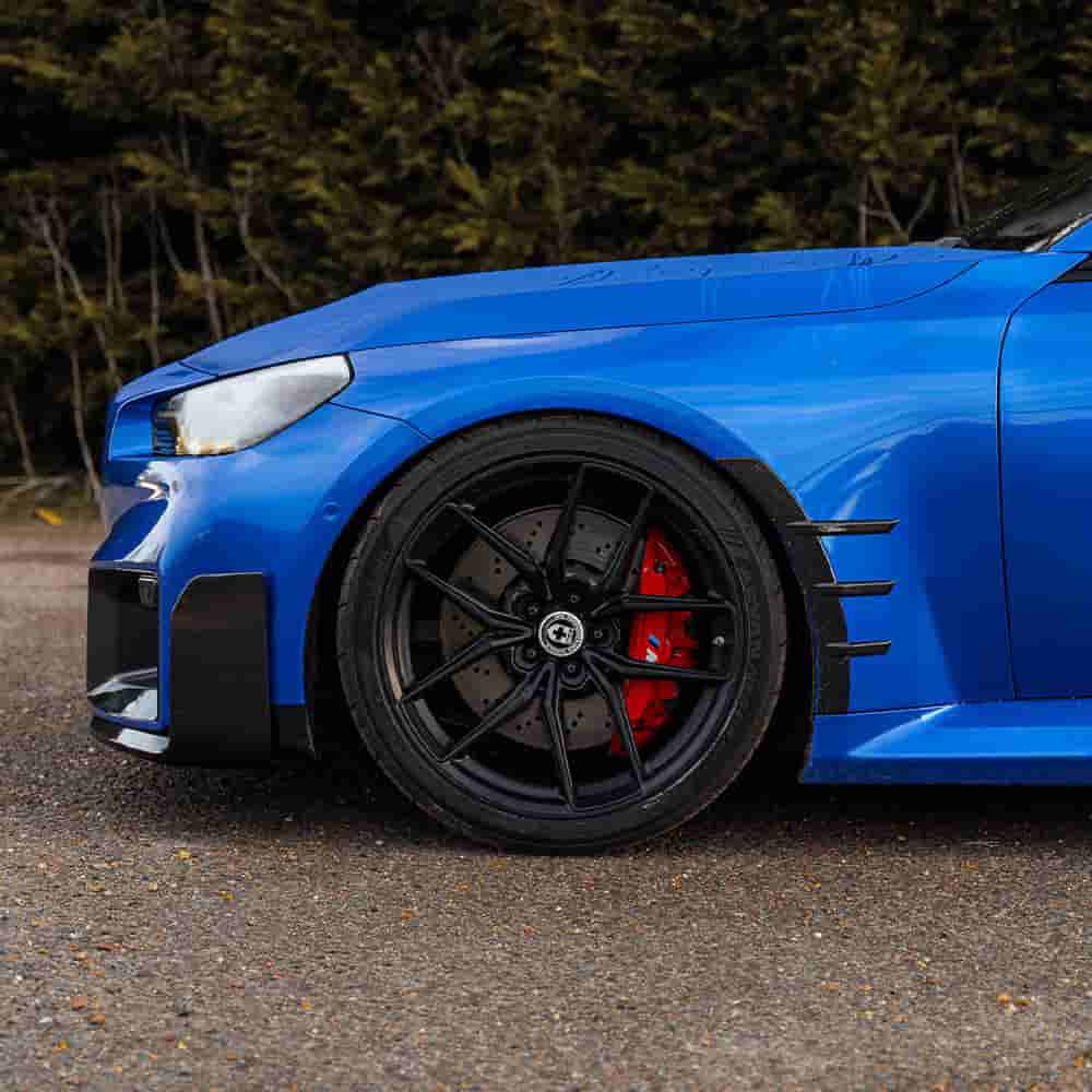 Front wheel-area reference on a blue vehicle.