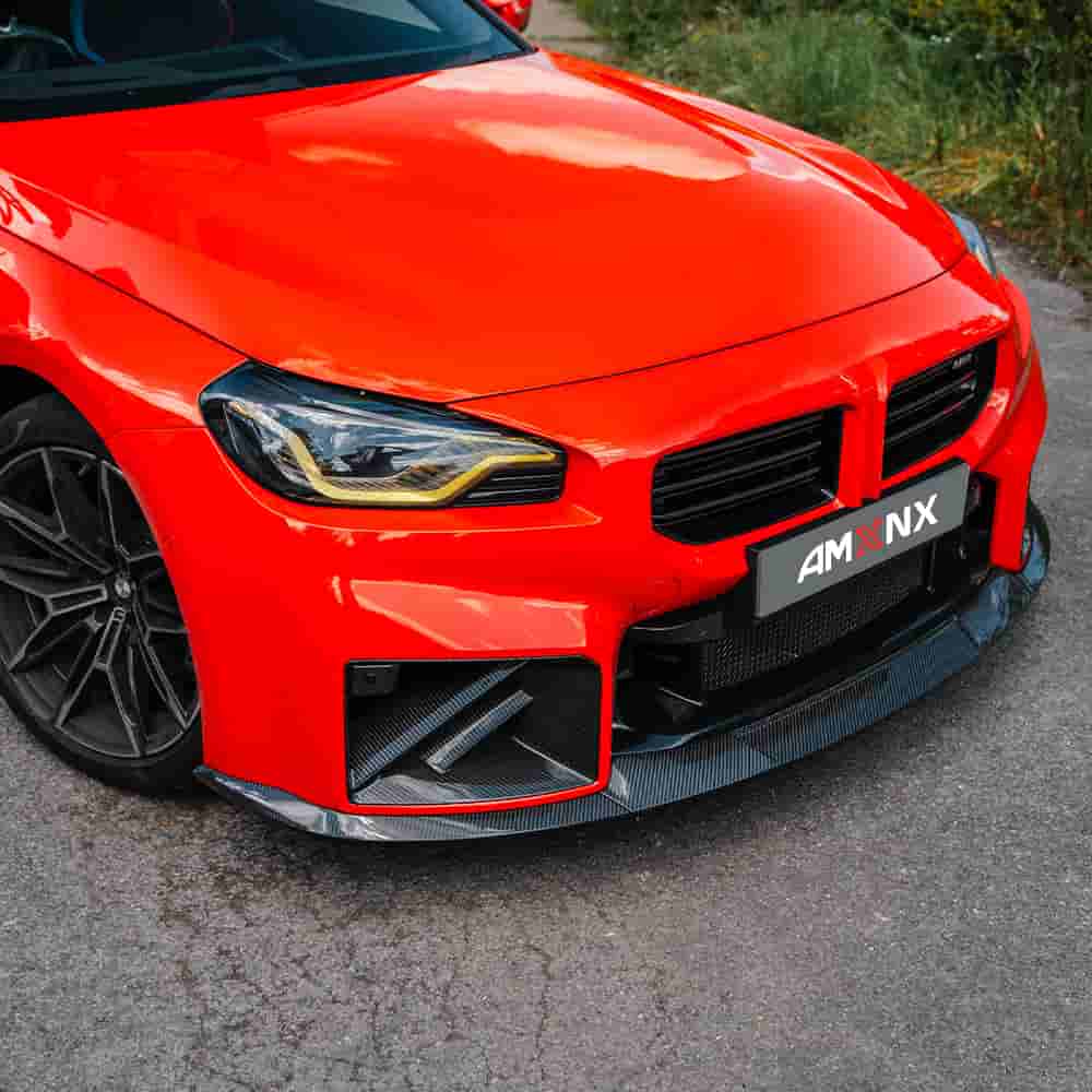Front-quarter view of a red BMW with bumper vent styling.