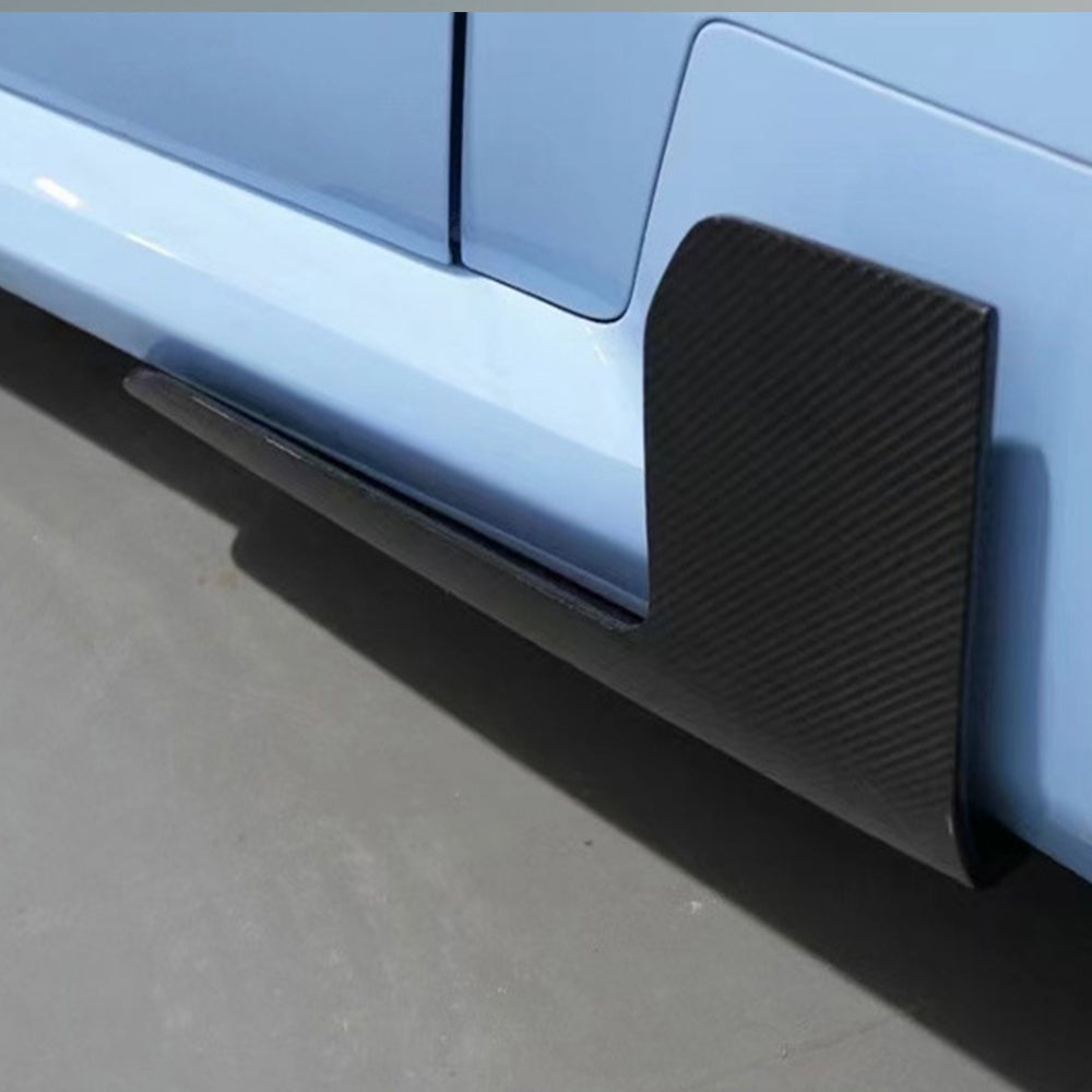 Side extension detail on a light blue vehicle near a wheel.