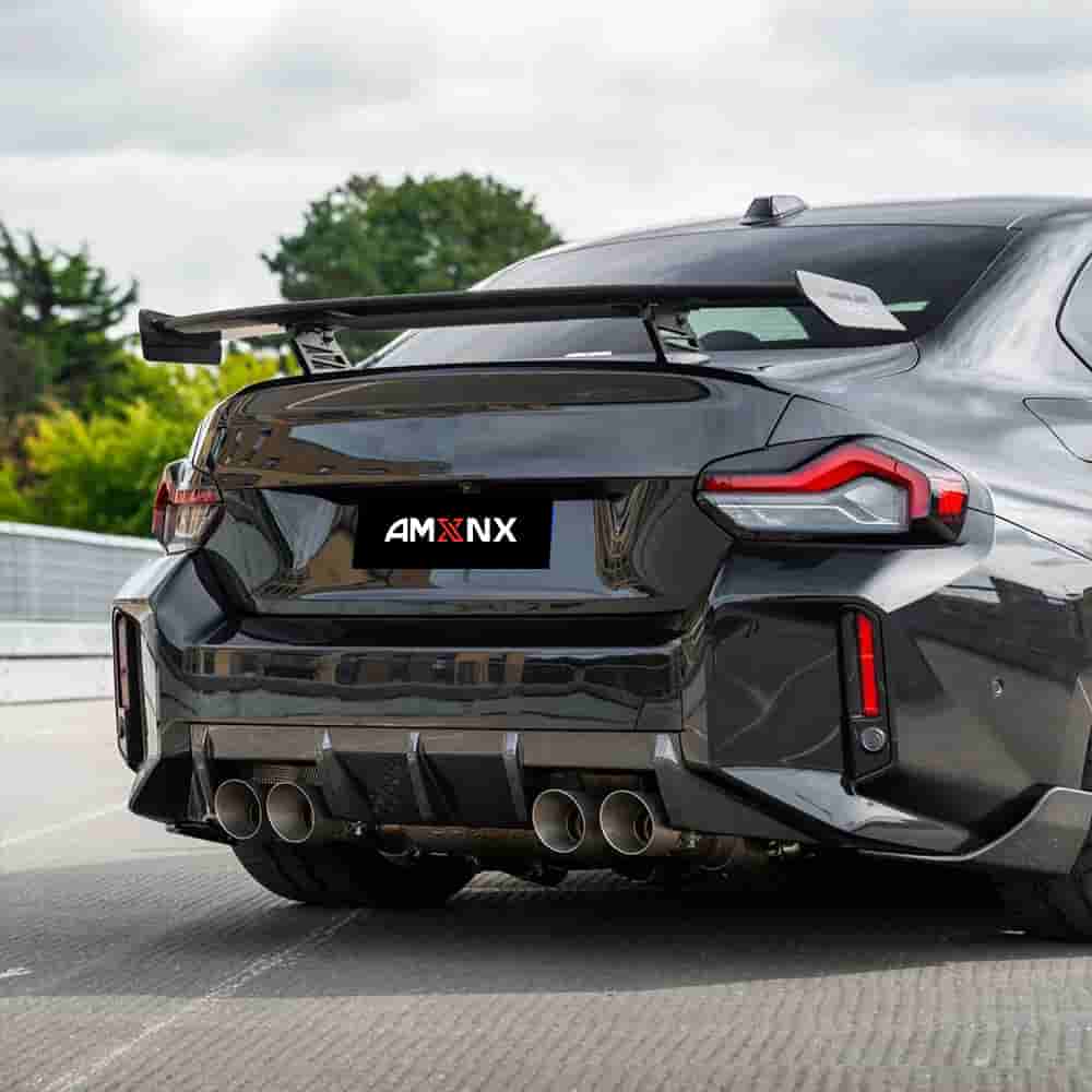 Rear view of a dark car with a diffuser and rear wing.