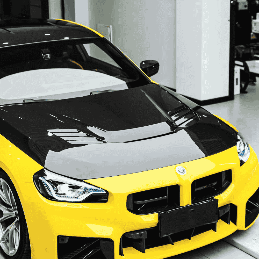 Hood styling reference on a yellow-and-white BMW.
