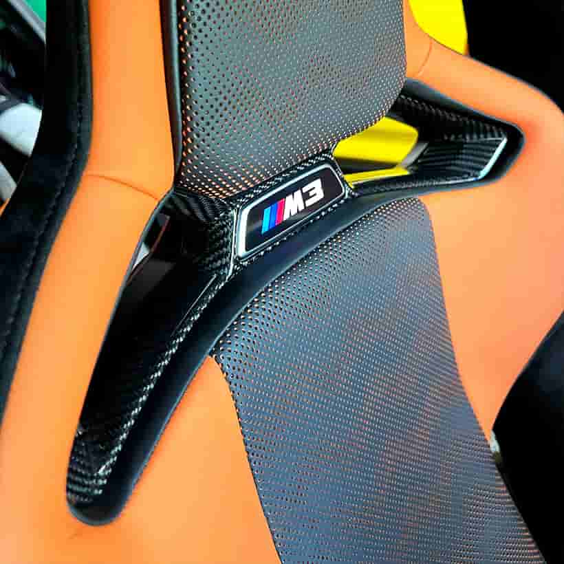 Close view of patterned trim around a seat opening.