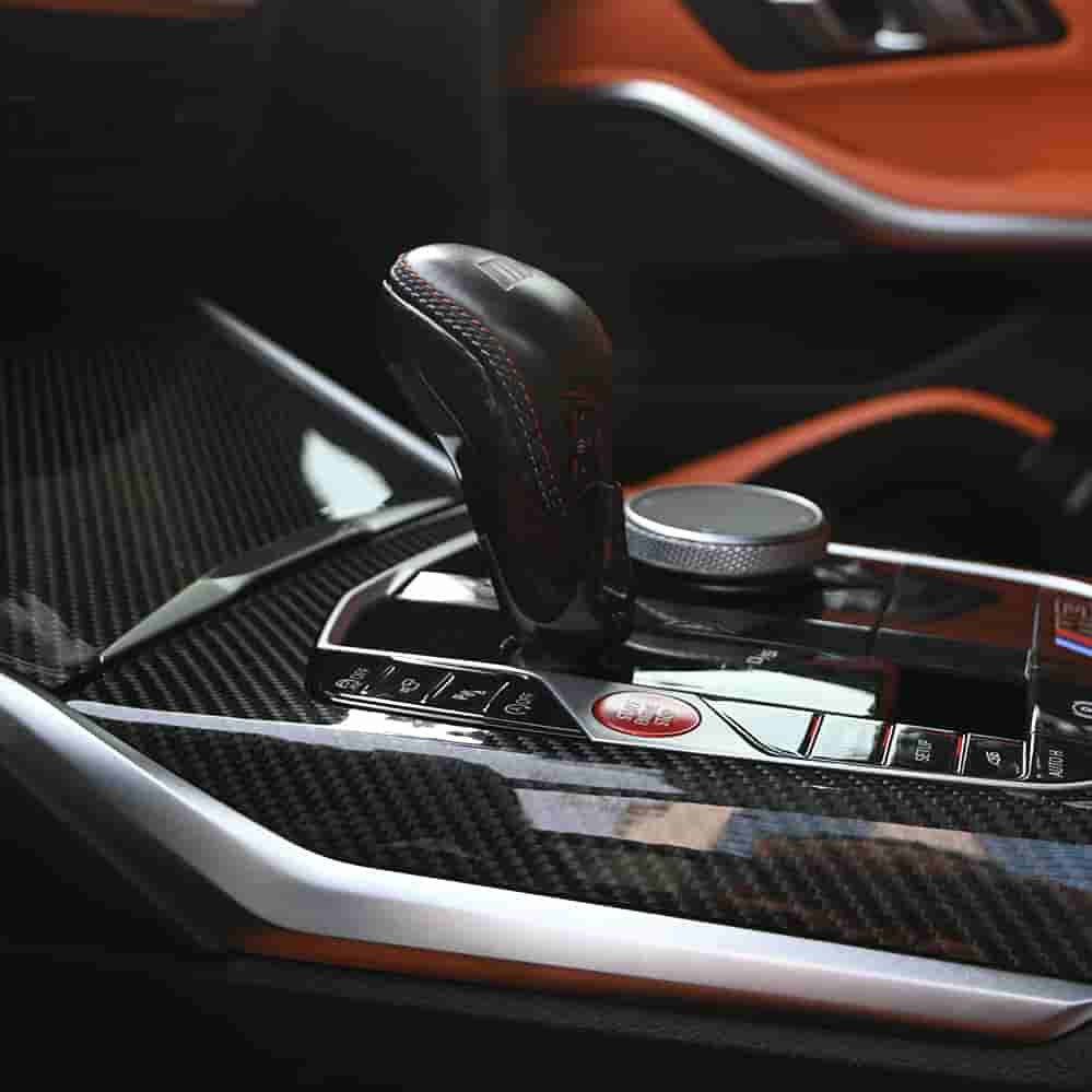Close view of a gear selector with patterned trim.
