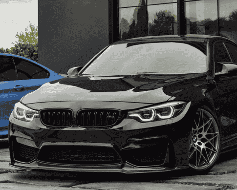 Front view of a dark BMW with a front lip.
