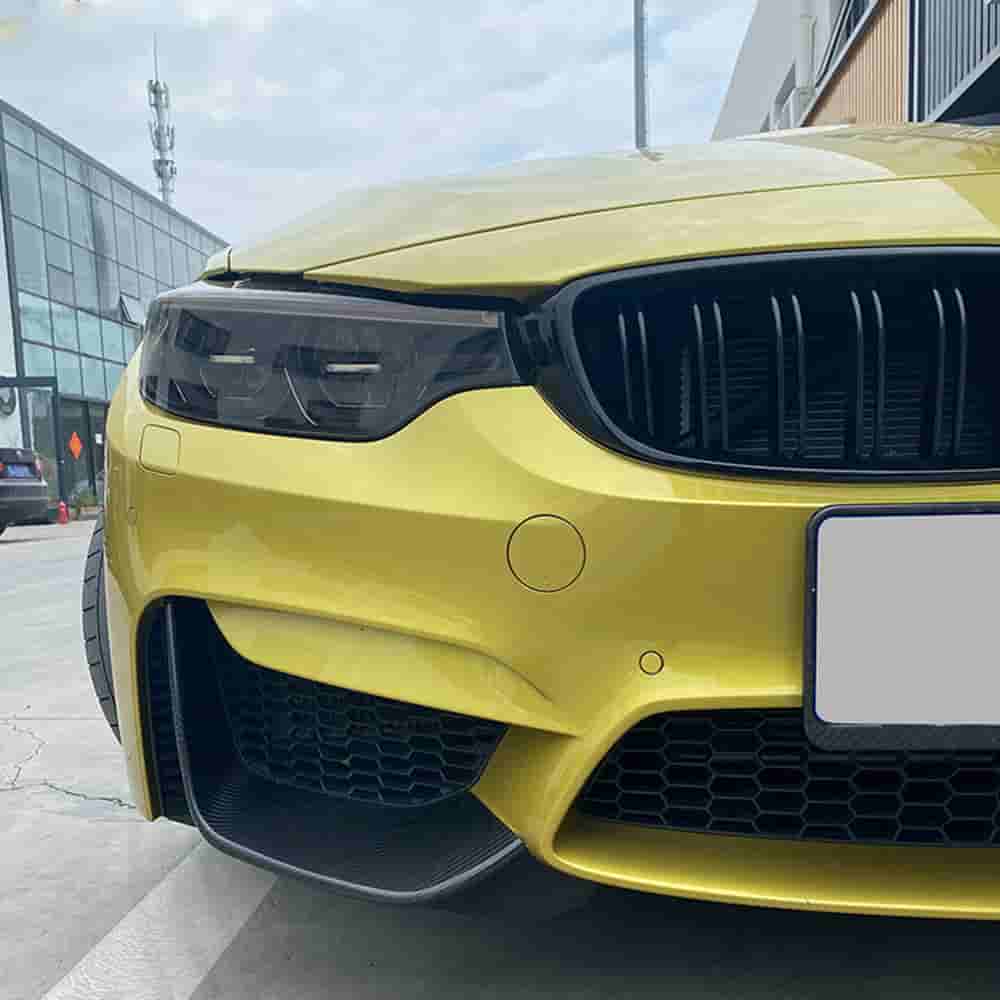 Front bumper corner detail on a yellow BMW.
