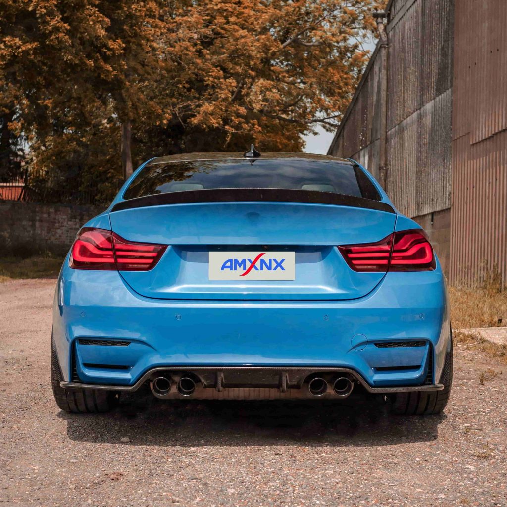 Rear view of a blue BMW with a diffuser.