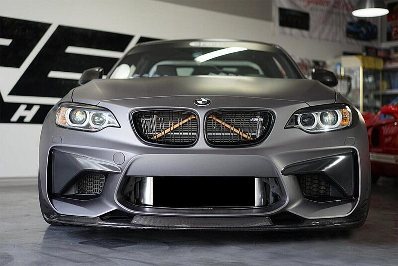 Front view of a gray BMW with lower bumper styling.