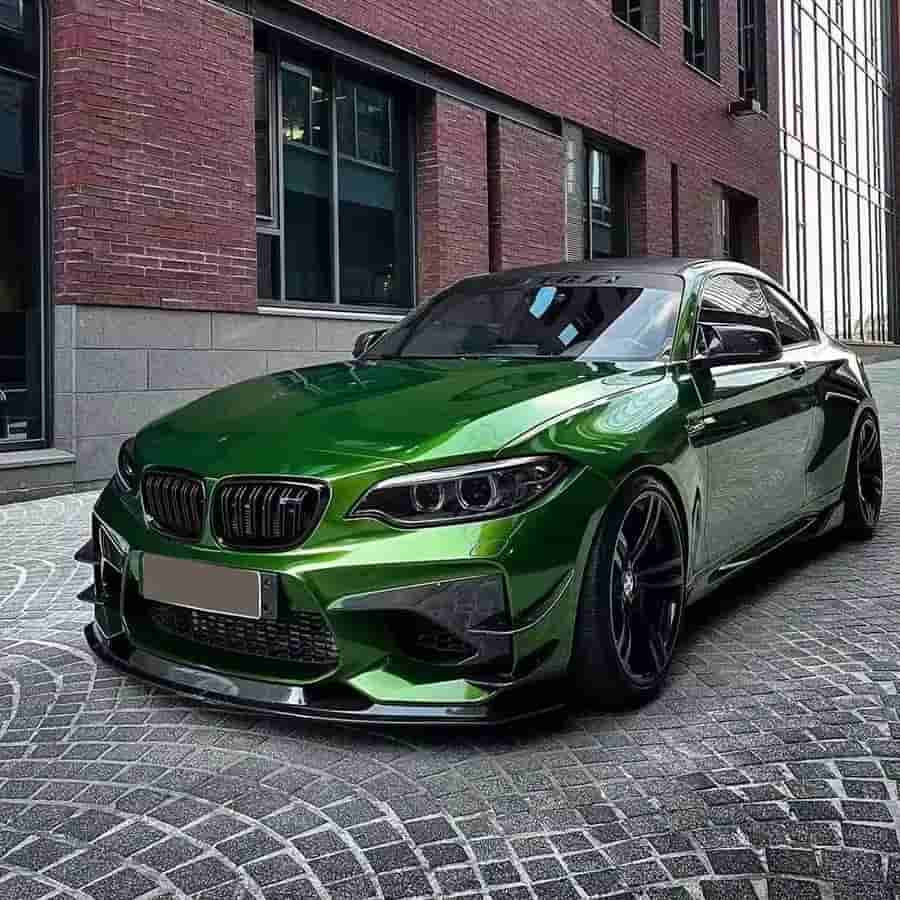 Front-quarter view of a green BMW with a front lip.