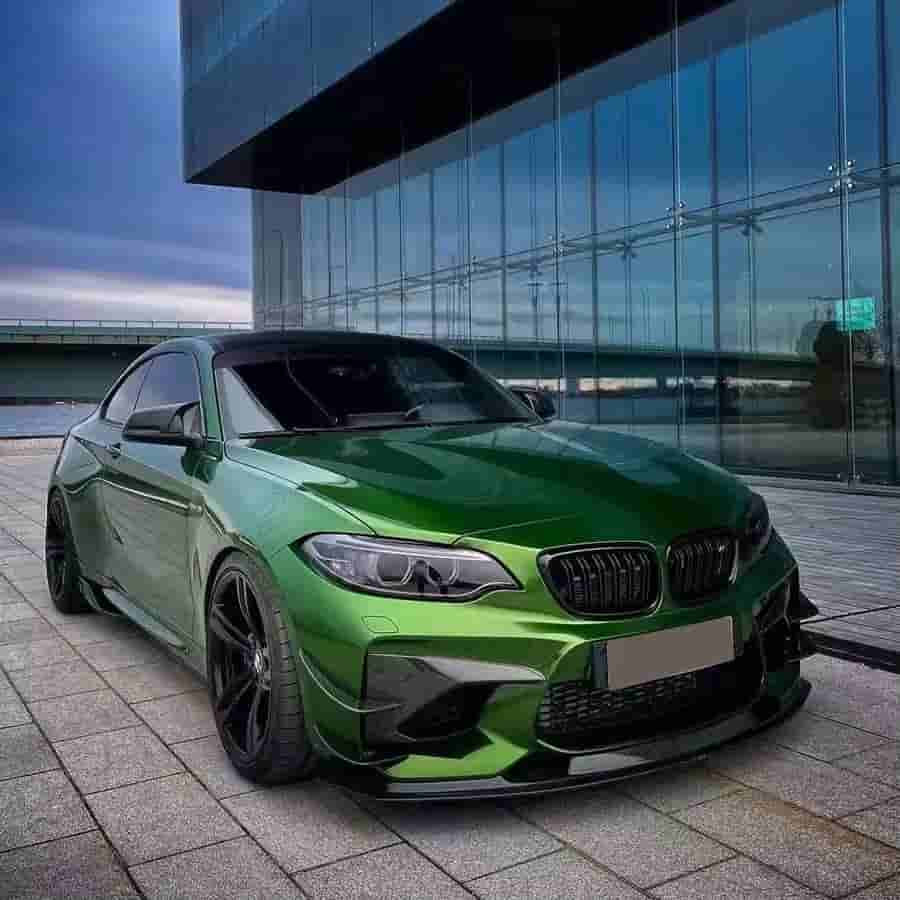 Front view at an angle of a green BMW.