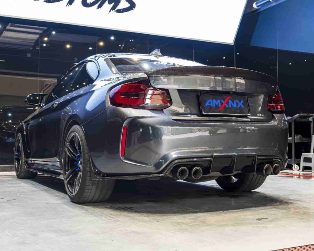 Rear-quarter vehicle reference showing a diffuser and exhaust tips.