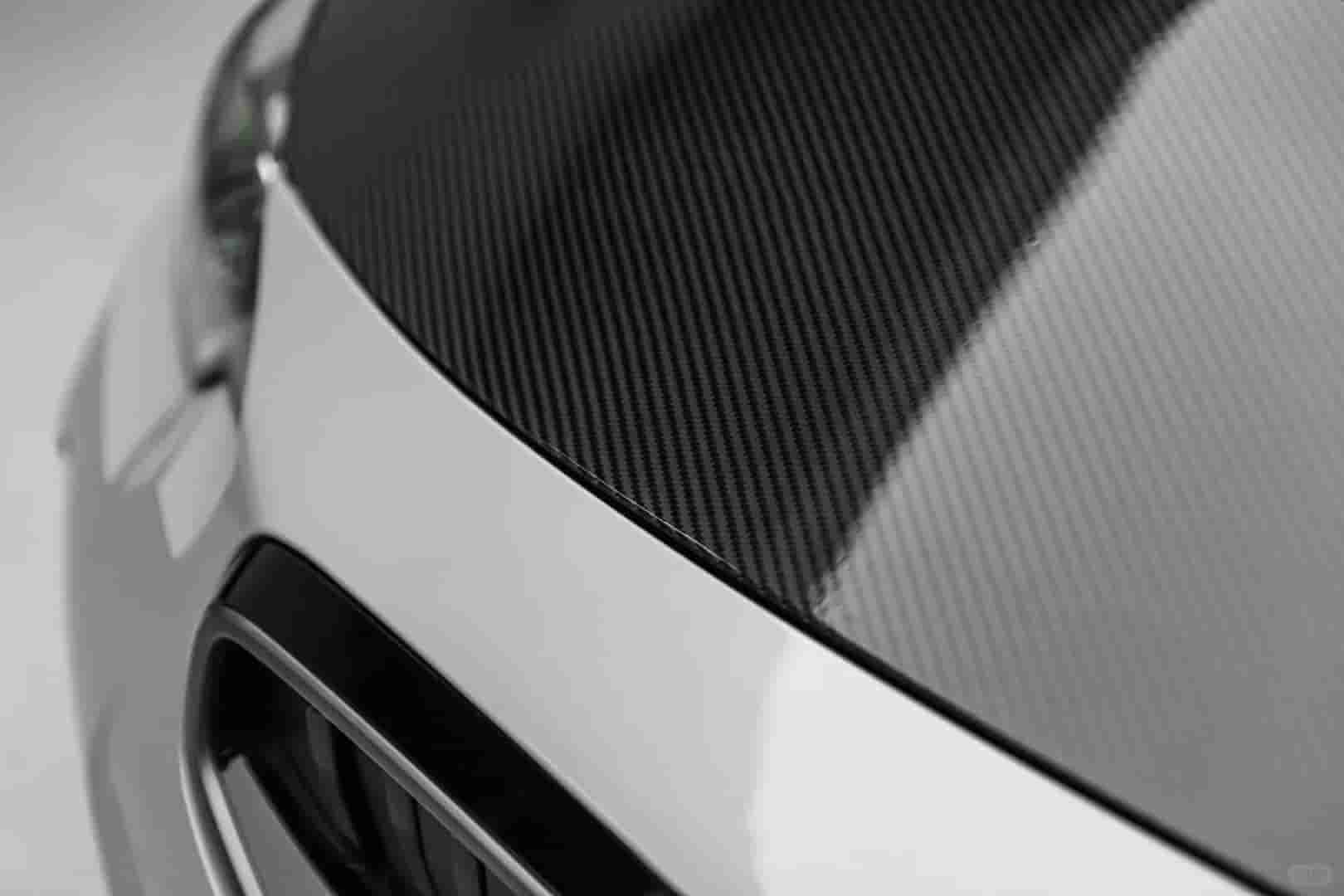 Close view of a hood edge and carbon-patterned surface.