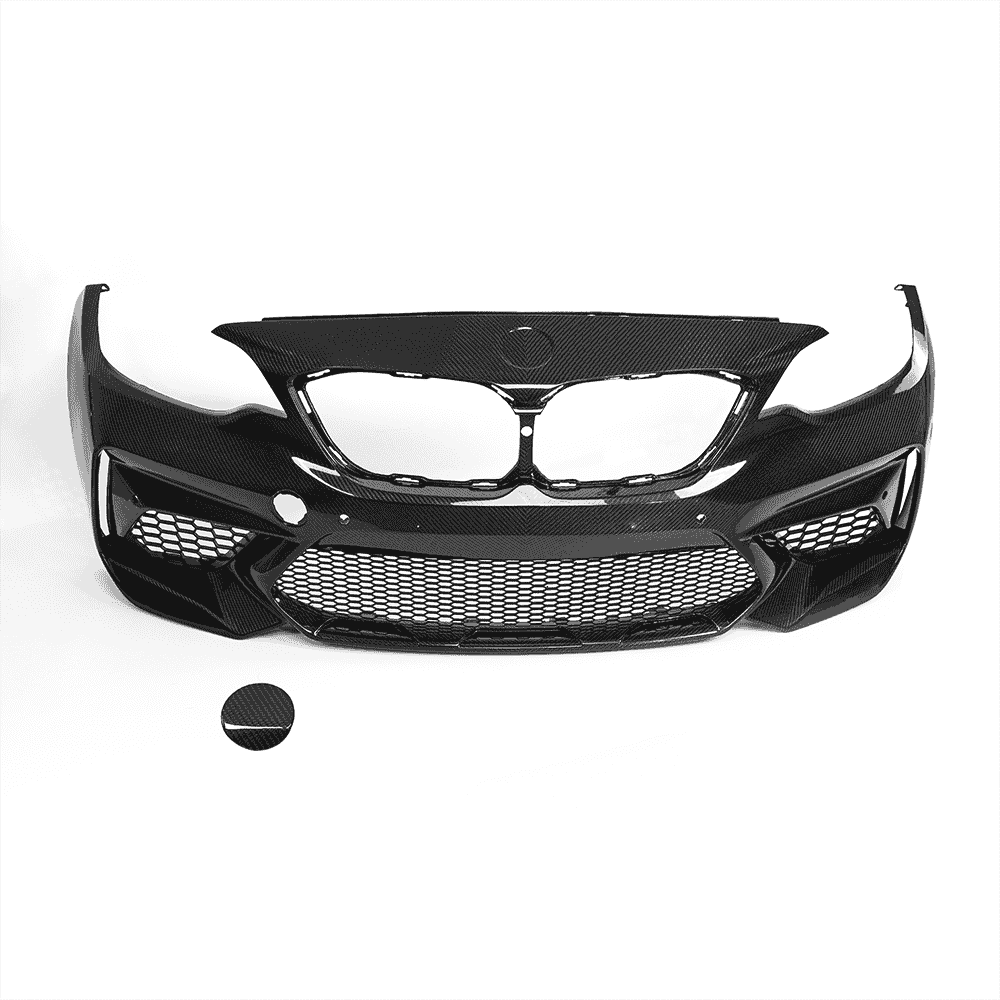 Front bumper cover with grille openings and a separate round piece.
