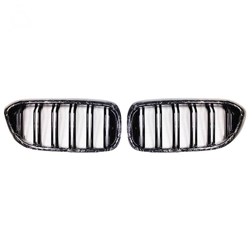 Pair of kidney grille pieces with vertical bars and patterned frames.