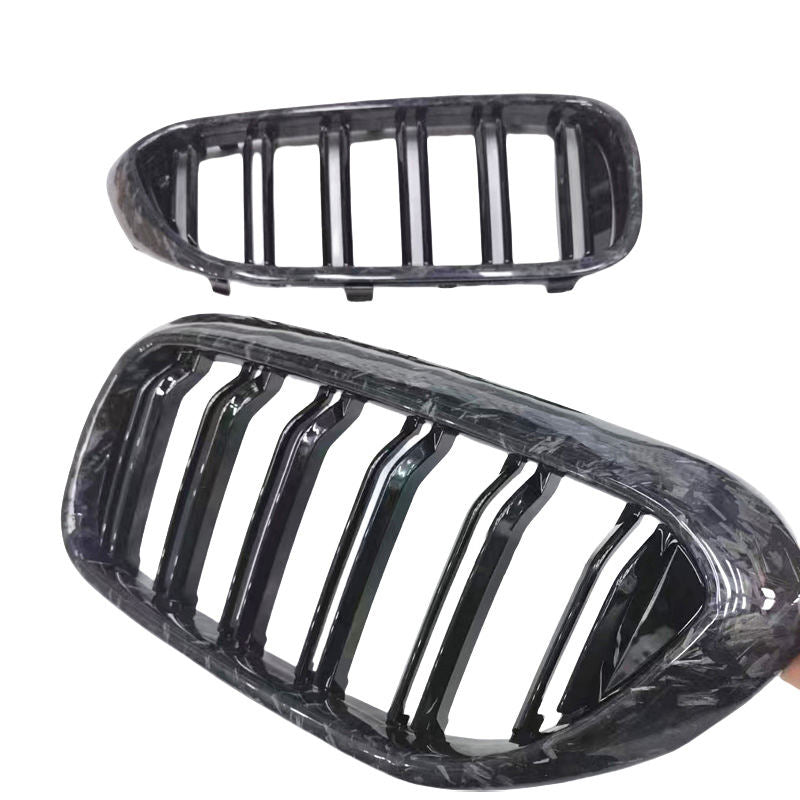 Angled view of two kidney grille pieces.