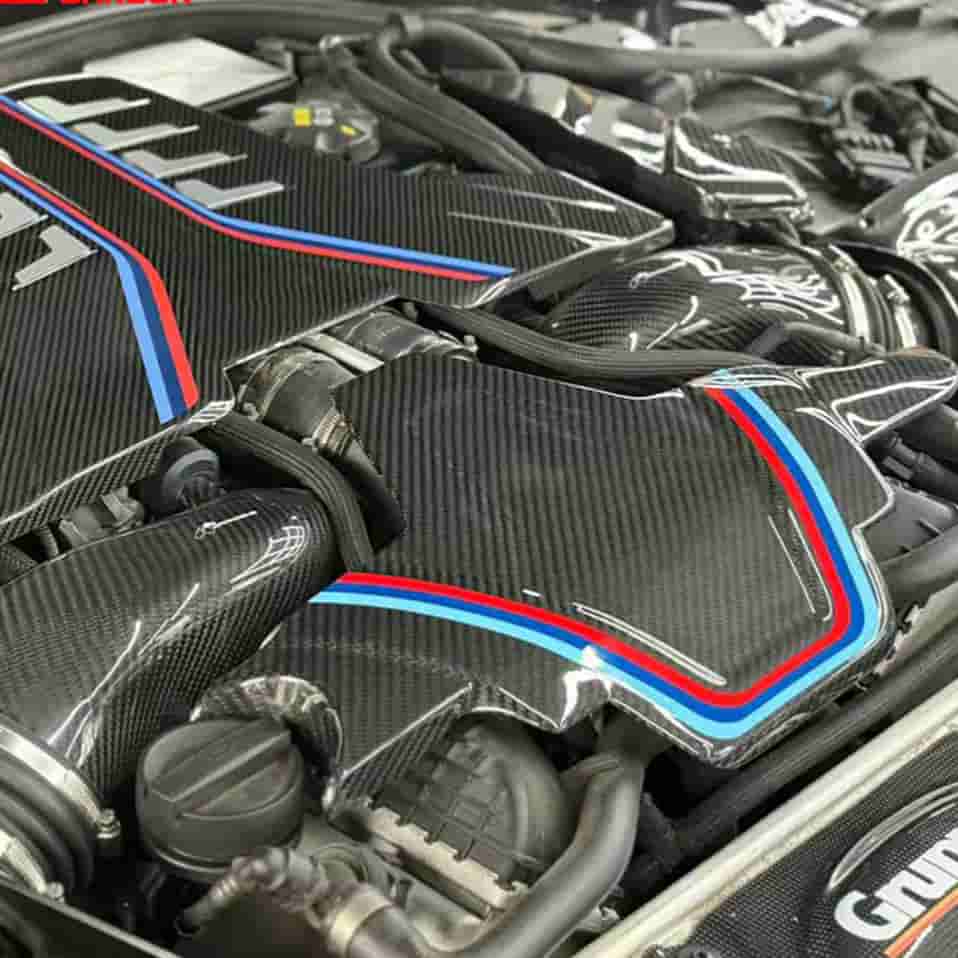 Engine-bay reference showing patterned trim beside an engine cover.