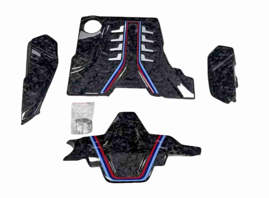 Engine-bay cover package with several irregular-patterned components.