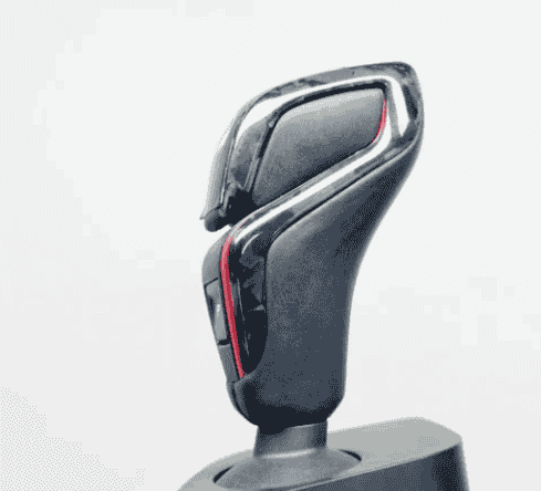 Close view of a gear selector with patterned trim.