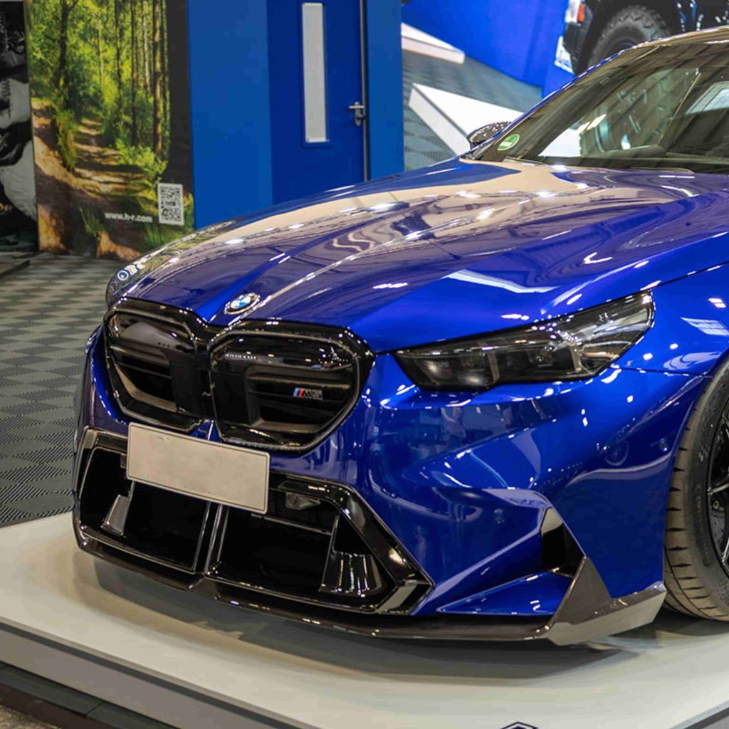 Front-quarter view of a blue BMW with lower bumper styling.