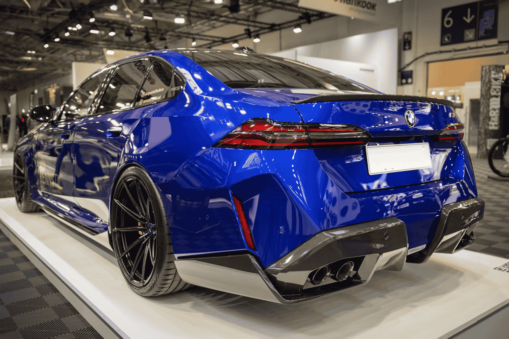 Rear-quarter close view of a blue BMW.