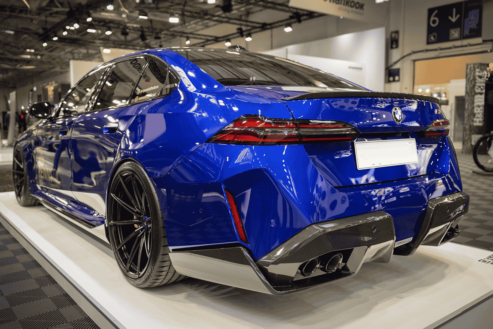 Rear-quarter close view of a blue BMW.