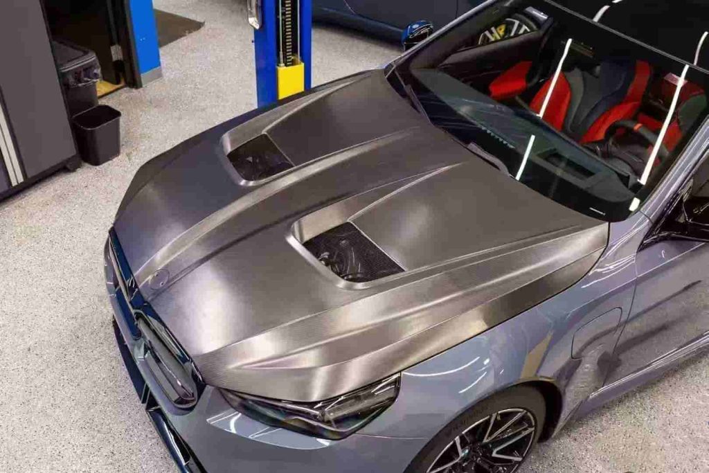 High front-quarter vehicle view showing hood openings.