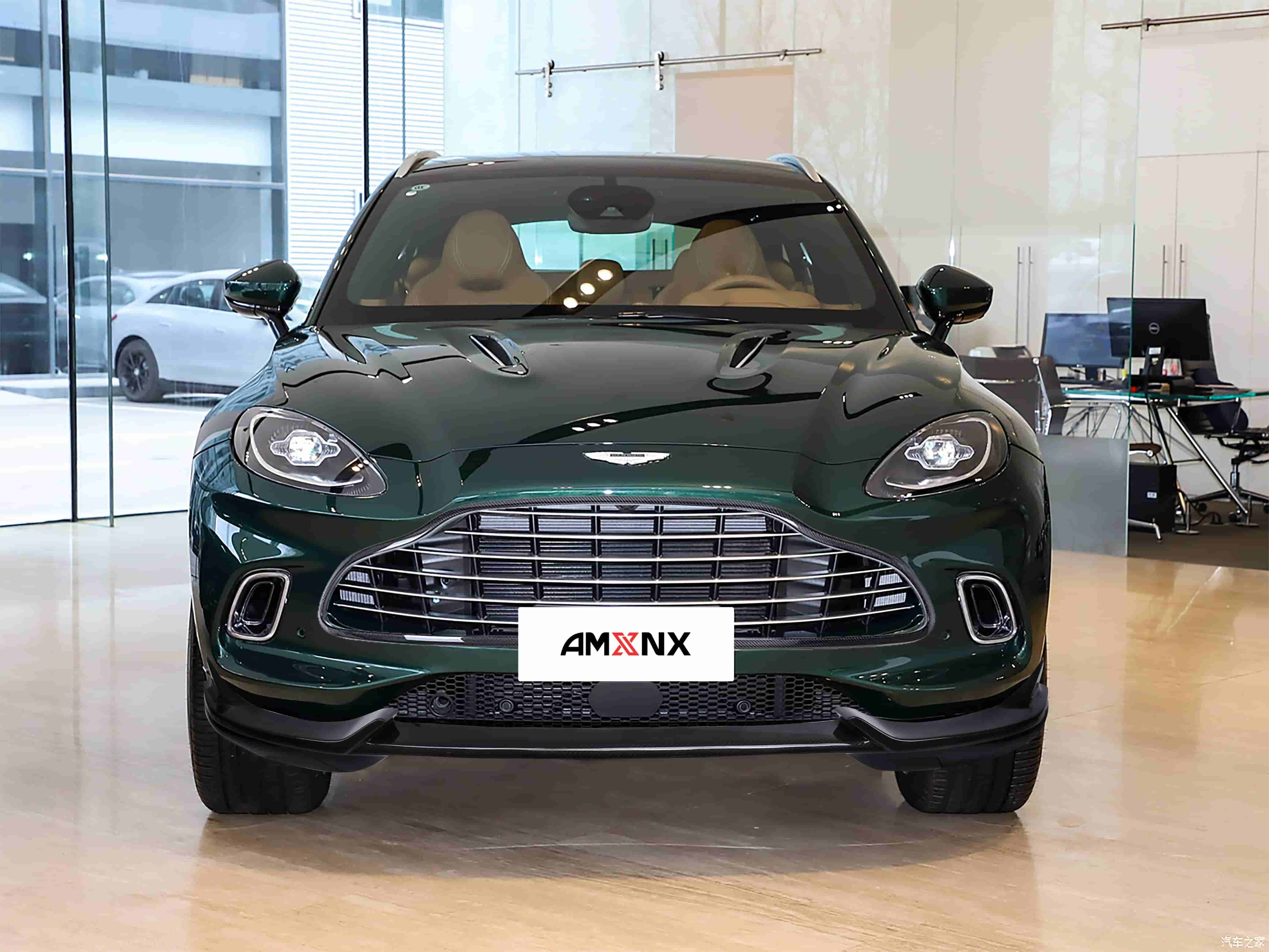 Front view of a dark green SUV with front styling.