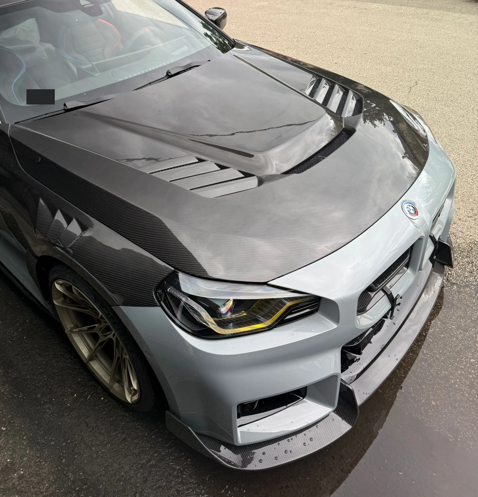 Customer photo of carbon fiber hood and front bodywork on a silver BMW.