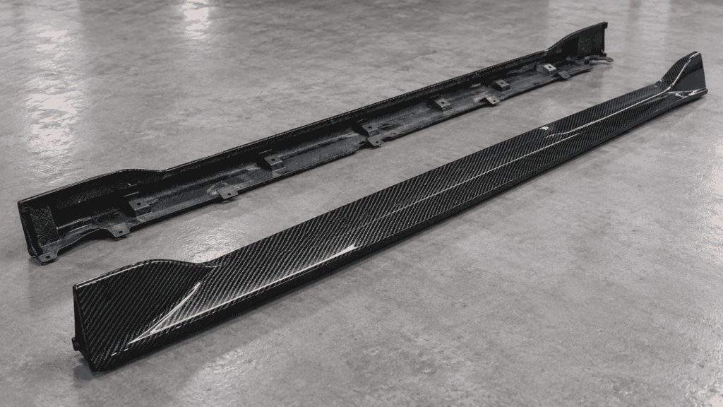Illustration: Two carbon side skirt concepts showing their outer surfaces and underside.