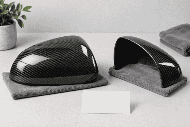 Concept of carbon mirror-cover shells on soft pads beside a blank comparison card.